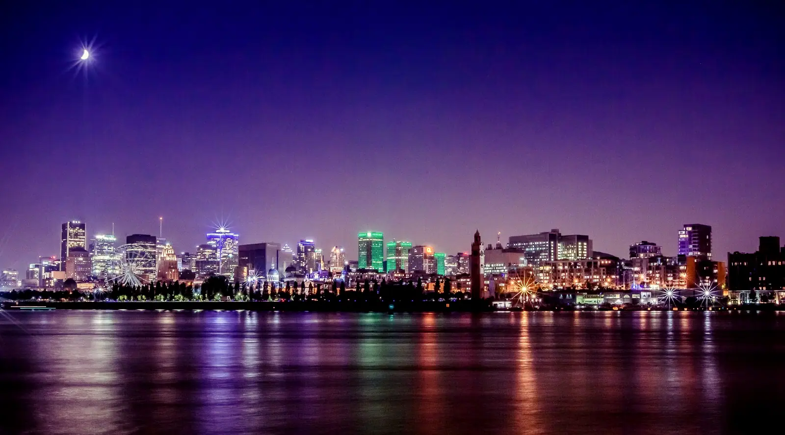 Montreal's skyline over the St. Lawrence at night